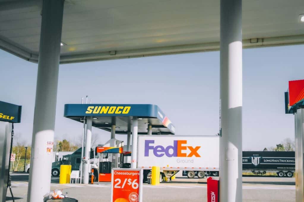 FedEx truck refueling at gas station representing fuel costs