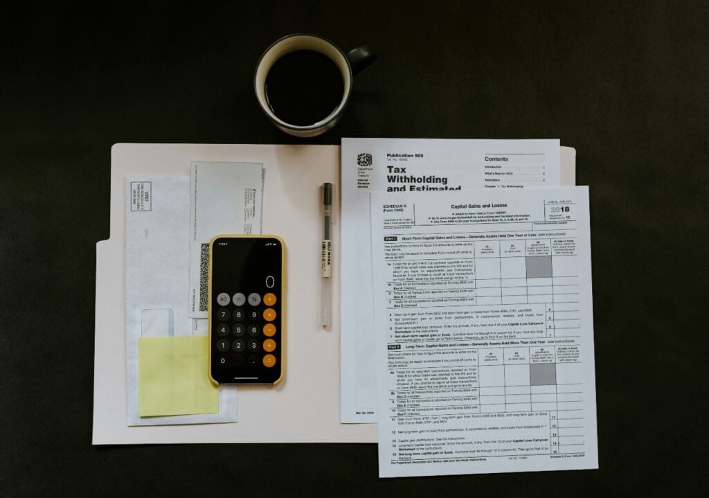 Calculator and tax paperwork representing net salary calculation