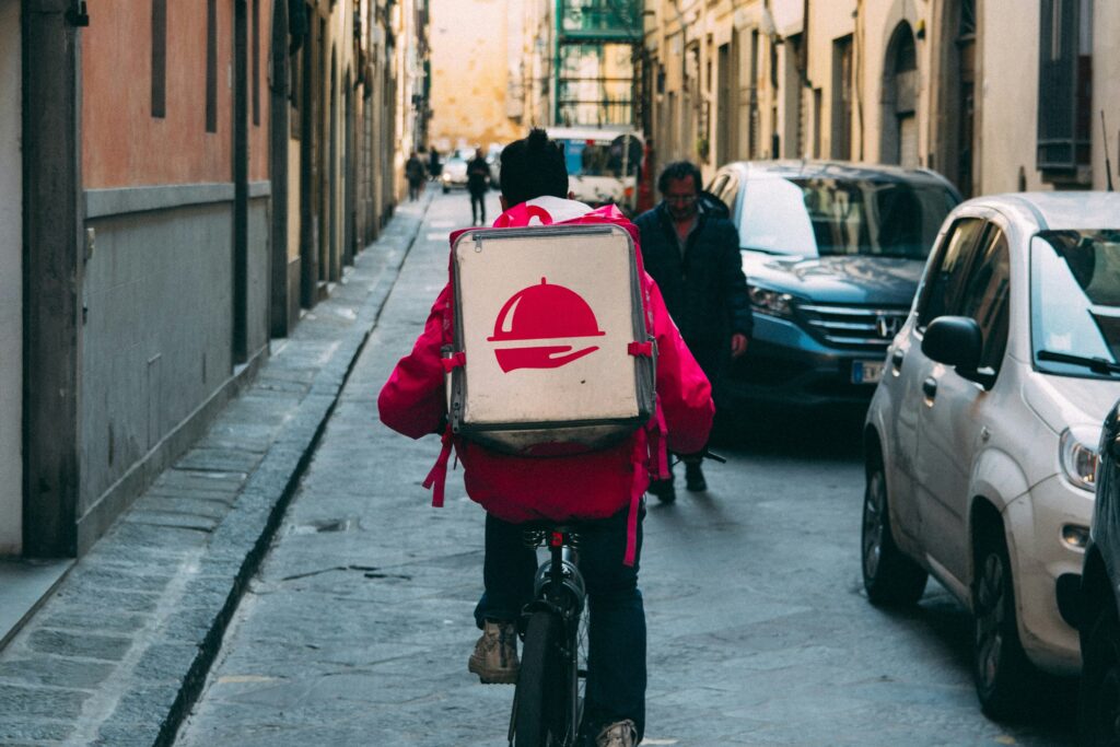 A guy is making deliveries on a bicycle to manage his student loan debt
