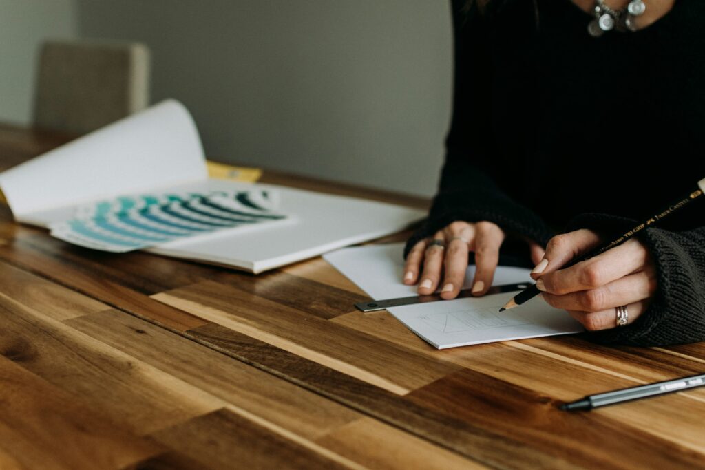 There are some papers lying on a table, and a guy is making his strategy on them.