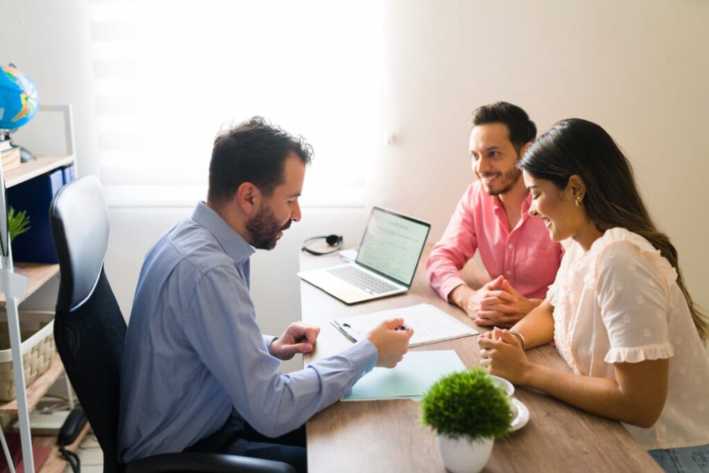 “Financial advisor discussing tax documents with a couple in a professional office setting”